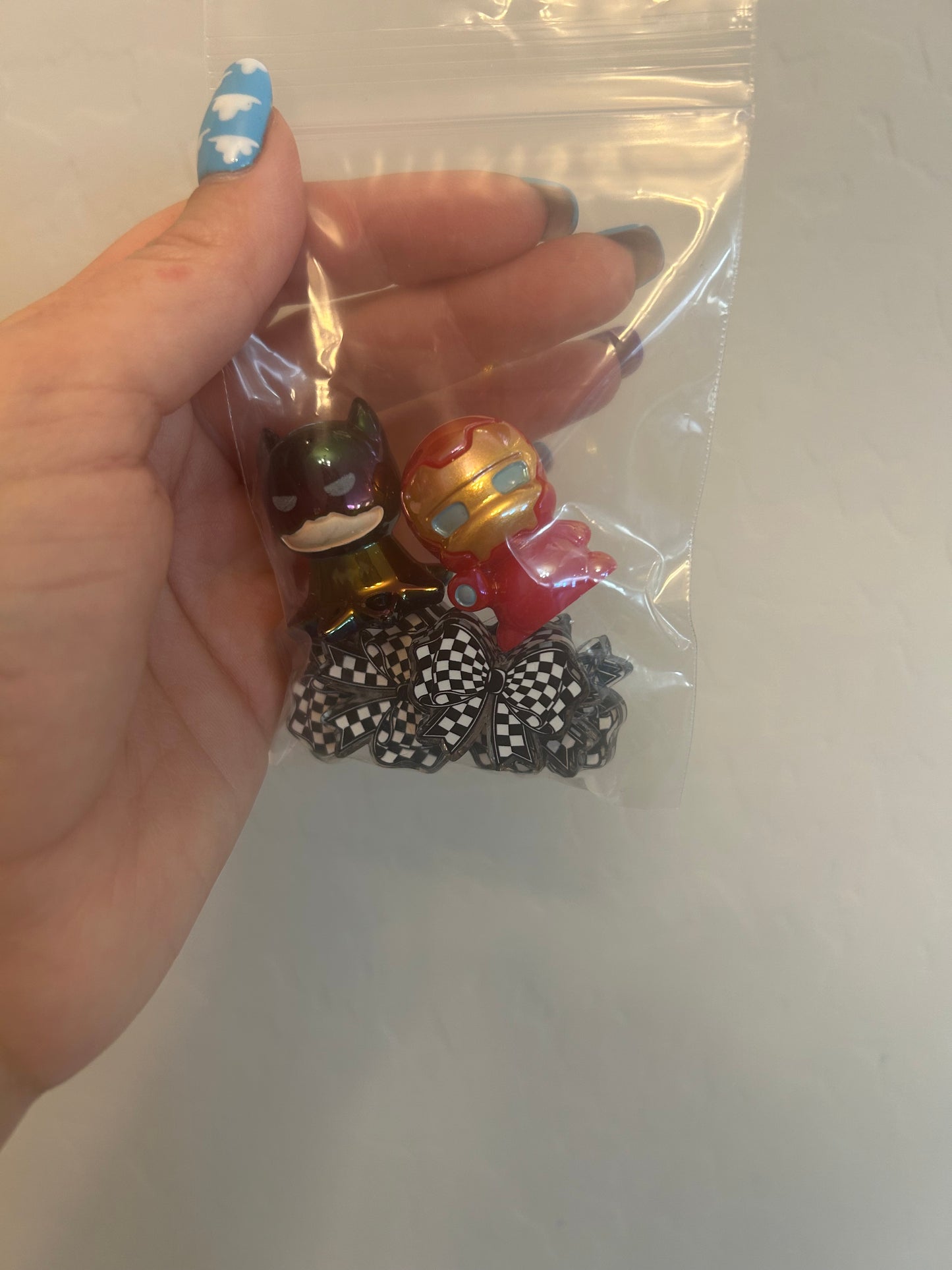 Checkered acrylic bows and 2 acrylic super heros